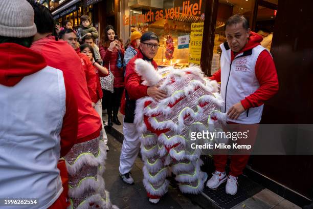 Lion Dance to celebrate the Chinese New Year of the Dragon exits a restaurant in Chinatown to bless them for the year ahead on 10th February 2024 in...