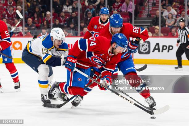Brandon Gignac of the Montreal Canadiens skates with the puck under pressure from Alexey Toropchenko of the St. Louis Blues during the first period...