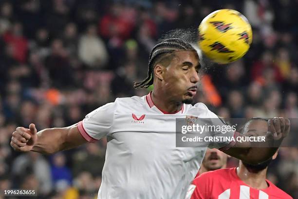 Sevilla's French defender Loic Bade heads the ball during the Spanish league football match between Sevilla FC and Club Atletico de Madrid at the...