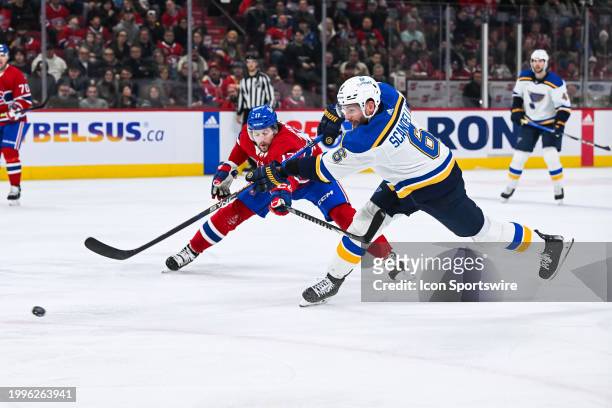 St. Louis Blues defenseman Marco Scandella shoots the puck as Montreal Canadiens right wing Josh Anderson attempts to defend during the St. Louis...
