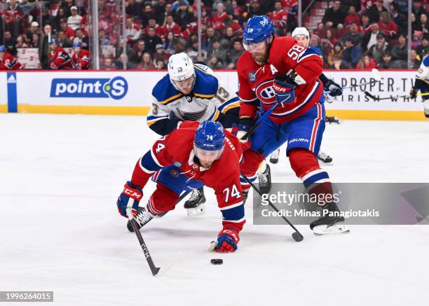 Brandon Gignac of the Montreal Canadiens and teammate David Savard skate after the puck against Alexey Toropchenko of the St. Louis Blues during the...