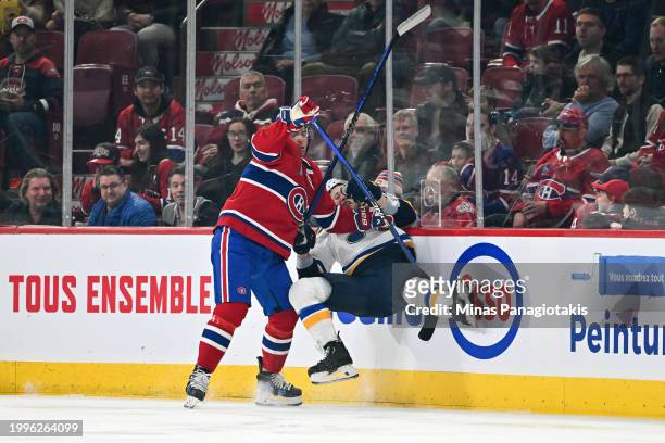 Tanner Pearson of the Montreal Canadiens checks Jake Neighbours of the St. Louis Blues into the boards during the first period at the Bell Centre on...