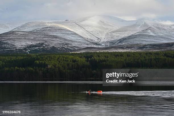 Wild swimmer braves the cold waters of Loch Morlich in the Cairngorms National Park, with the Cairngorm ski area in the background, on February 11,...