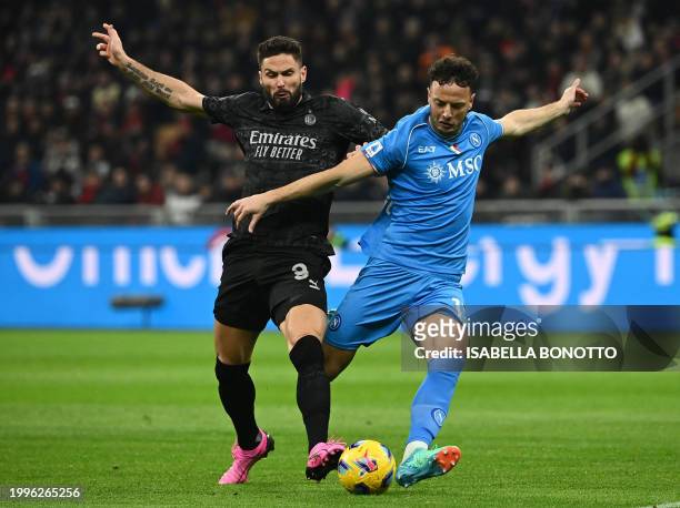 Napoli's Kosovo defender Amir Rrahmani fights for the ball with AC Milan's French forward Olivier Giroud during the Italian Serie A football match...
