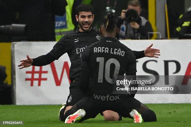 Milan's French defender Theo Hernandez celebrates with his teammate AC Milan's Portuguese forward Rafael Leao after scoring during the Italian Serie...