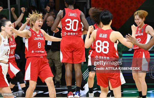 Japan's players celebratate their victory over Canada after the 2024 FIBA Women's Olympic qualifying tournament basketball match between Canada and...