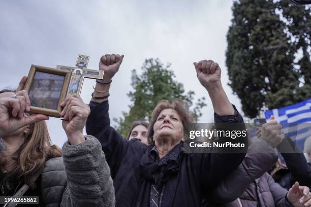 People are holding Greek flags and religious icons during a gathering of members of the religious conservative party ''Niki,'' members of...