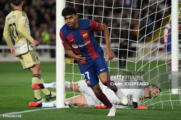 Barcelona's Spanish forward Lamine Yamal celebrates scoring the opening goal during the Spanish league football match between FC Barcelona and...