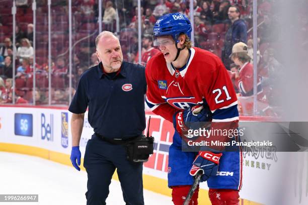 Medical staff tend to Kaiden Guhle of the Montreal Canadiens during the third period against the St. Louis Blues at the Bell Centre on February 11,...