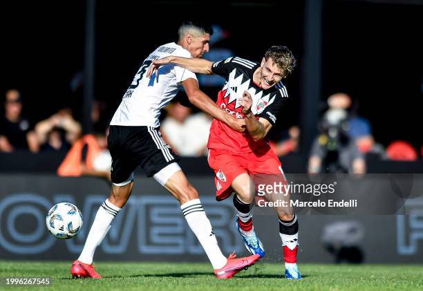 Facundo Colidio of River Plate competes for the ball with Nicolas Caro Torres of Deportivo Riestra during a Copa de la Liga 2024 group A match...