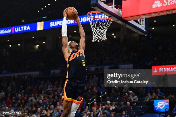 Shai Gilgeous-Alexander of the Oklahoma City Thunder rises up for a slam dunk during the first half against the Sacramento Kings at Paycom Center on...