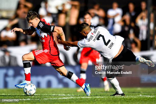 Facundo Colidio of River Plate competes for the ball with Nahuel Iribarren of Deportivo Riestra during a Copa de la Liga 2024 group A match between...