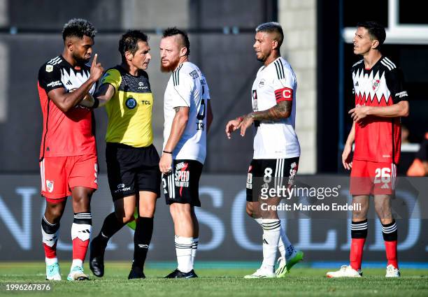 Miguel Borja of River Plate argues with Nicolas Dematei of Deportivo Riestra during a Copa de la Liga 2024 group A match between Deportivo Riestra...