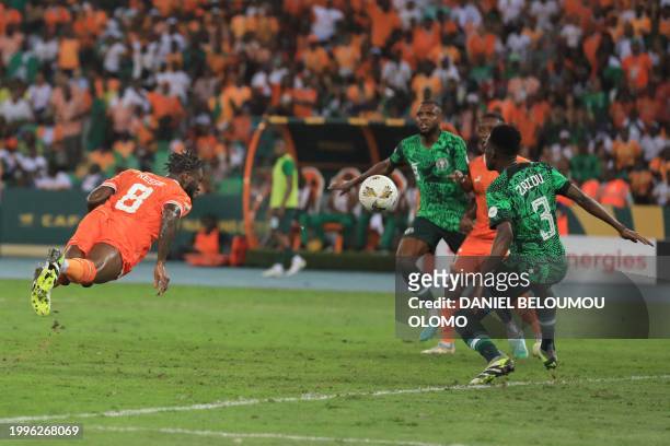 Ivory Coast's midfielder Franck Kessie heads the ball to score his team's first goal during the Africa Cup of Nations 2024 final football match...