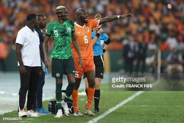Ivory Coast's midfielder Seko Fofana reacts next to Nigeria's forward Victor Osimhen during the Africa Cup of Nations 2024 final football match...