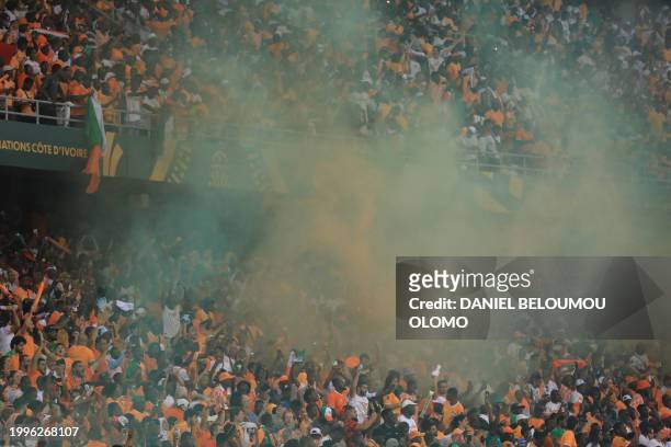 Ivory Coast supporters cheer in the stands during the Africa Cup of Nations 2024 final football match between Ivory Coast and Nigeria at Alassane...