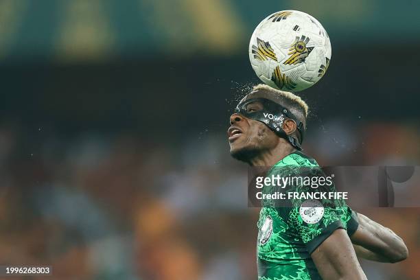 Nigeria's forward Victor Osimhen heads the ball during the Africa Cup of Nations 2024 final football match between Ivory Coast and Nigeria at...