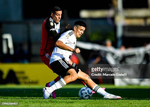 Ramiro Funes Mori of River Plate competes for the ball with Nicolas Benegas of Deportivo Riestra during a Copa de la Liga 2024 group A match between...
