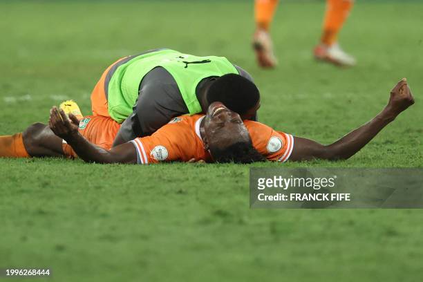 Ivorian players celebrate after winning at the end of the Africa Cup of Nations 2024 final football match between Ivory Coast and Nigeria at Alassane...