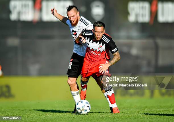 Esequiel Barco of River Plate competes for the ball with Nicolas Dematei of Deportivo Riestra during a Copa de la Liga 2024 group A match between...