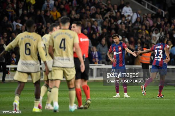 Barcelona's Spanish forward Lamine Yamal is congratulated by Barcelona's French defender Jules Kounde for scoring his team's third goal during the...