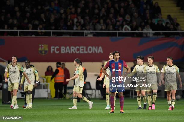 Barcelona's French defender Jules Kounde reacts to Granada's Spanish defender Ignasi Miquel's goal during the Spanish league football match between...