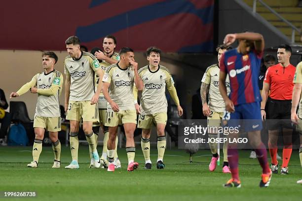Granada players celebrate their third goal scored by Granada's Spanish defender Ignasi Miquel during the Spanish league football match between FC...