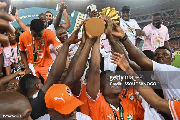 Ivory Coast players lift the trophy on the podium after Ivory Coast won the Africa Cup of Nations 2024 final football match between Ivory Coast and...