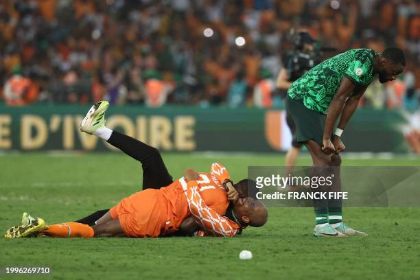 Ivorian players celebrate after winning at the end of the Africa Cup of Nations 2024 final football match between Ivory Coast and Nigeria at Alassane...