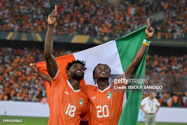 Ivory Coast's midfielder Ibrahim Sangare and Ivory Coast's forward Christian Kouame celebrate after Ivory Coast won the Africa Cup of Nations 2024...