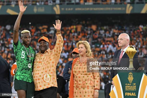 Nigeria's forward Victor Osimhen waves to the crowd next to President of Ivory Coast Alassane Ouattara , First Lady of Ivory Coast Dominique Ouattara...