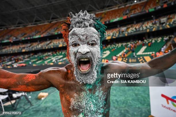 An Ivorian supporter celebrates after winning at the end of the Africa Cup of Nations 2024 final football match between Ivory Coast and Nigeria at...