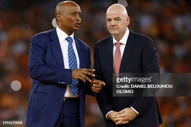 President of the Confederation of African Football Patrice Motsepe speaks to President of FIFA Gianni Infantino on the podium after Ivory Coast won...