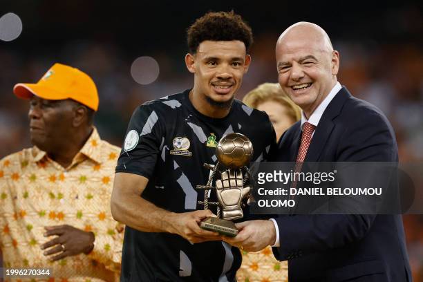 South Africa's goalkeeper Ronwen Williams receives the Golden Glove award from President of FIFA Gianni Infantino during prize giving ceremony...