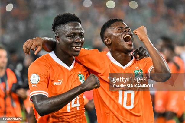 Ivory Coast's forward Oumar Diakite and Ivory Coast's forward Karim Konate celebrate after winning at the end of the Africa Cup of Nations 2024 final...