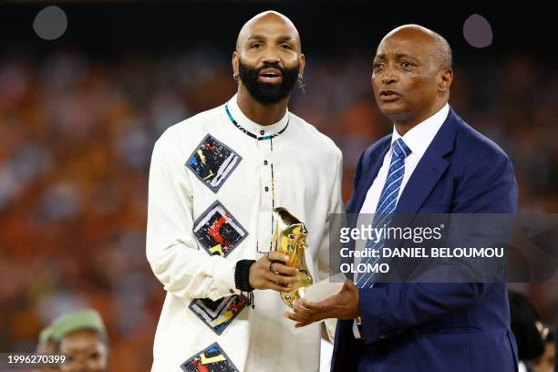 Equatorial Guinea's forward Emilio Nsue holds the best player award as he stands next to President of the Confederation of African Football Patrice...
