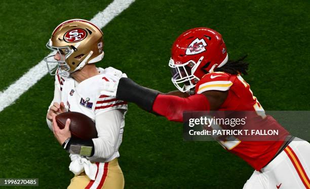 Kansas City Chiefs' linebacker Nick Bolton holds San Francisco 49ers' quarterback Brock Purdy during Super Bowl LVIII between the Kansas City Chiefs...