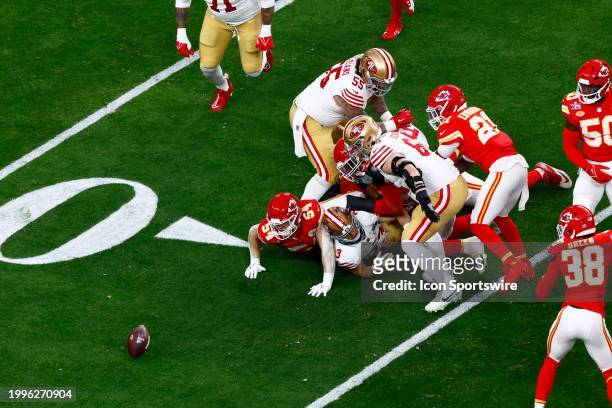 San Francisco 49ers running back Christian McCaffrey fumbles the ball in the first quarter during Super Bowl LVIII between the Kansas City Chiefs and...