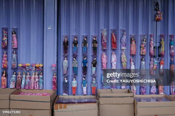 Dolls are displayed for sale on a street in Jakarta on February 11, 2024.