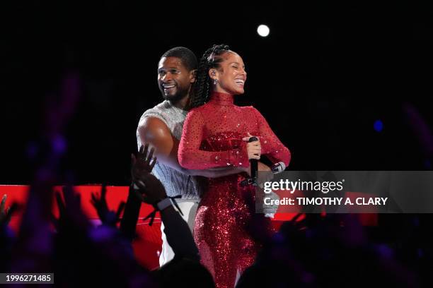 Singer-songwriter Usher performs with US singer-songwriter Alicia Keys during Apple Music halftime show of Super Bowl LVIII between the Kansas City...