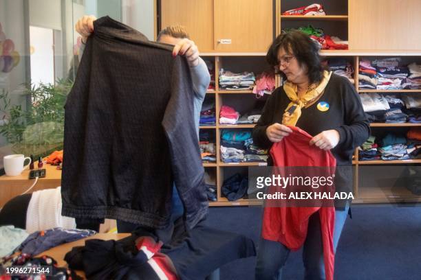 Volunteers sort clothes at the Matusya association which supports Ukrainian refugees in Vienna, Austria on February 8, 2024. Almost two years after...
