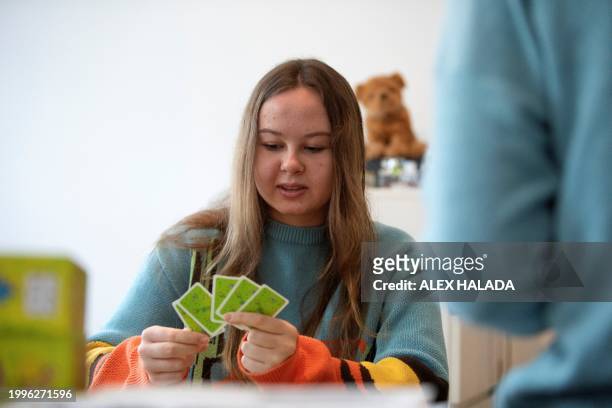 Katya Troshchenko from southern Ukraine plays cards with her mother and grandmother in their apartment in Vienna, Austria on February 8, 2024. Almost...