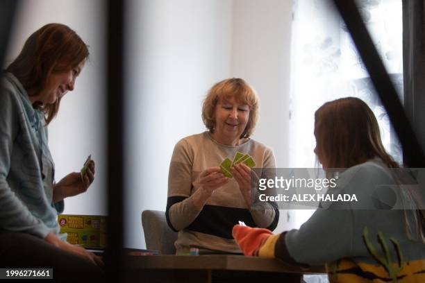 Mother Maryna Troshchenko from southern Ukraine with her daughter Katya Troshchenko and grandmother Iryna Simonova play cards in their apartment in...