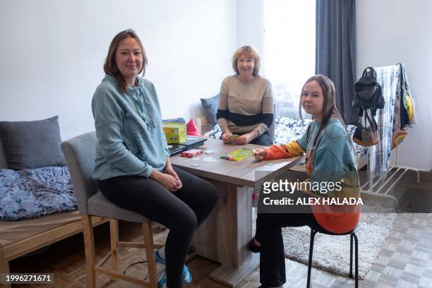Mother Maryna Troshchenko from southern Ukraine with her daughter Katya Troshchenko and grandmother Iryna Simonova pose for photos in their apartment...
