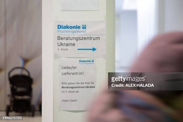 Photo taken in Vienna, Austria on February 8, 2024 shows a sign at the entrance to the Ukrainian refugee advice centre of the Diakonie help...
