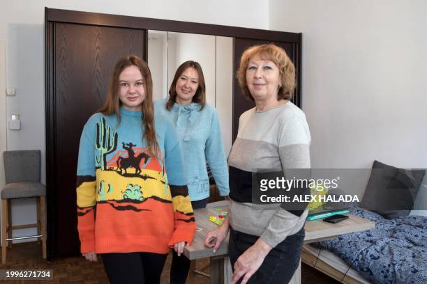 Mother Maryna Troshchenko from southern Ukraine with her daughter Katya Troshchenko and grandmother Iryna Simonova pose for photos in their apartment...