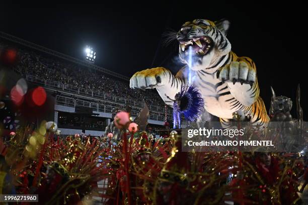 Members of the Porto da Pedra samba school perform during the first night of the Carnival parade at the Marques de Sapucai Sambadrome in Rio de...