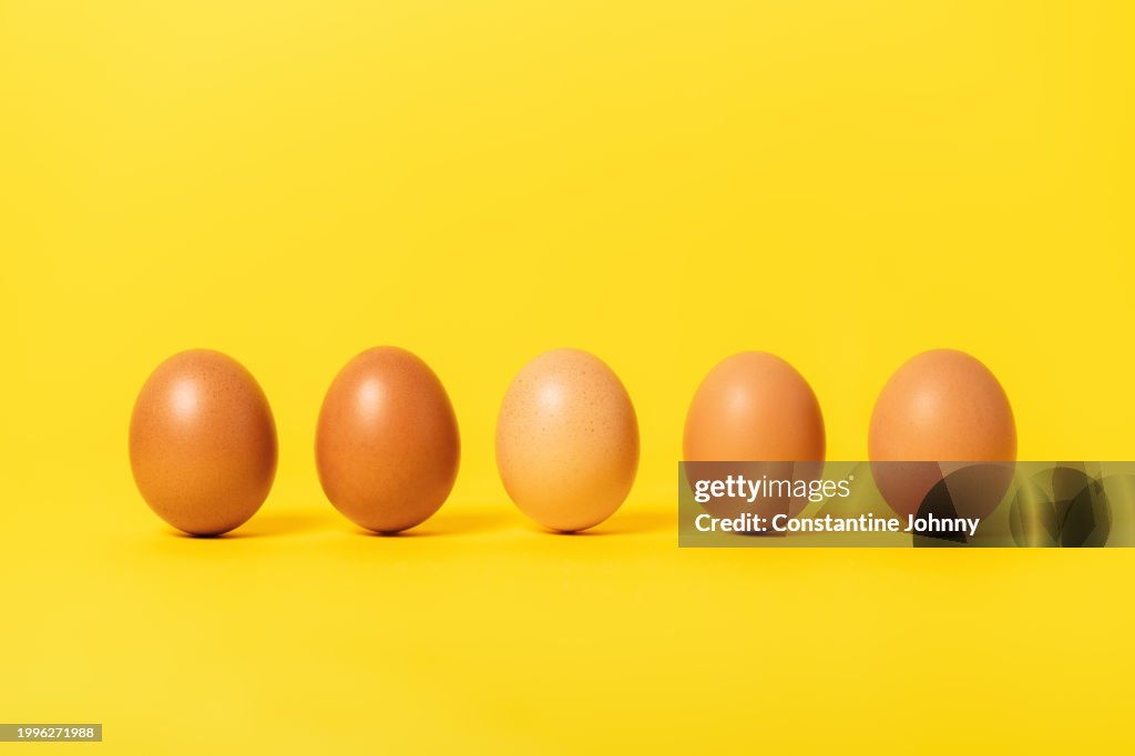 Brown Chicken Eggs on Yellow Background