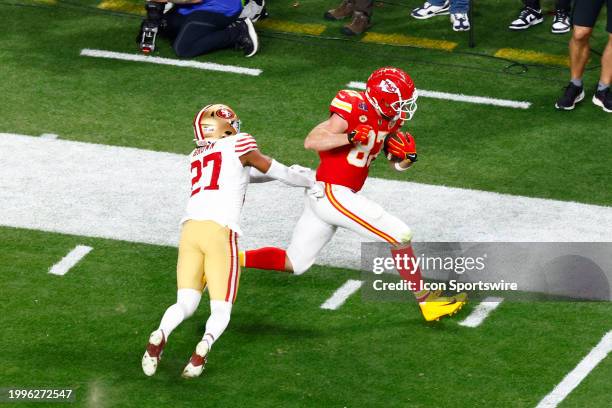 Kansas City Chiefs tight end Travis Kelce runs the ball for a critical gain late in the fourth quarter during Super Bowl LVIII between the Kansas...