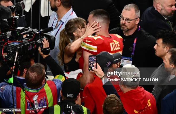 Singer-songwriter Taylor Swift kisses Kansas City Chiefs' tight end Travis Kelce after the Chiefs won Super Bowl LVIII against the San Francisco...